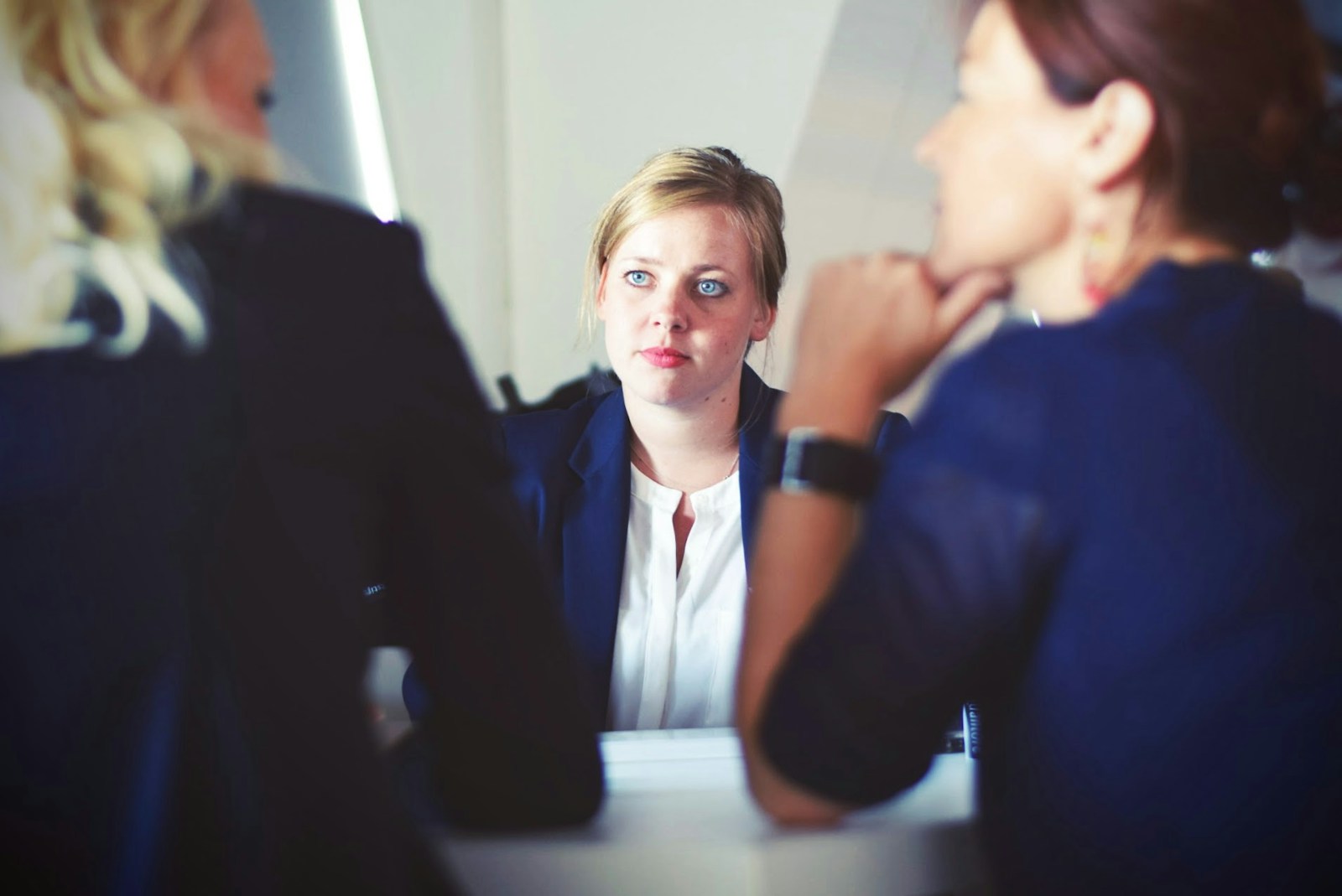 Photo by Tim Gouw three women sitting beside table